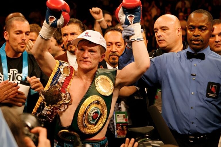 Boxer celebrating with championship belts in a Zapply men's health editorial image