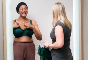 Two women smiling together in a Bravissimo fitting room