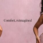 Model wearing Bravissimo lingerie in a softly lit campaign setting