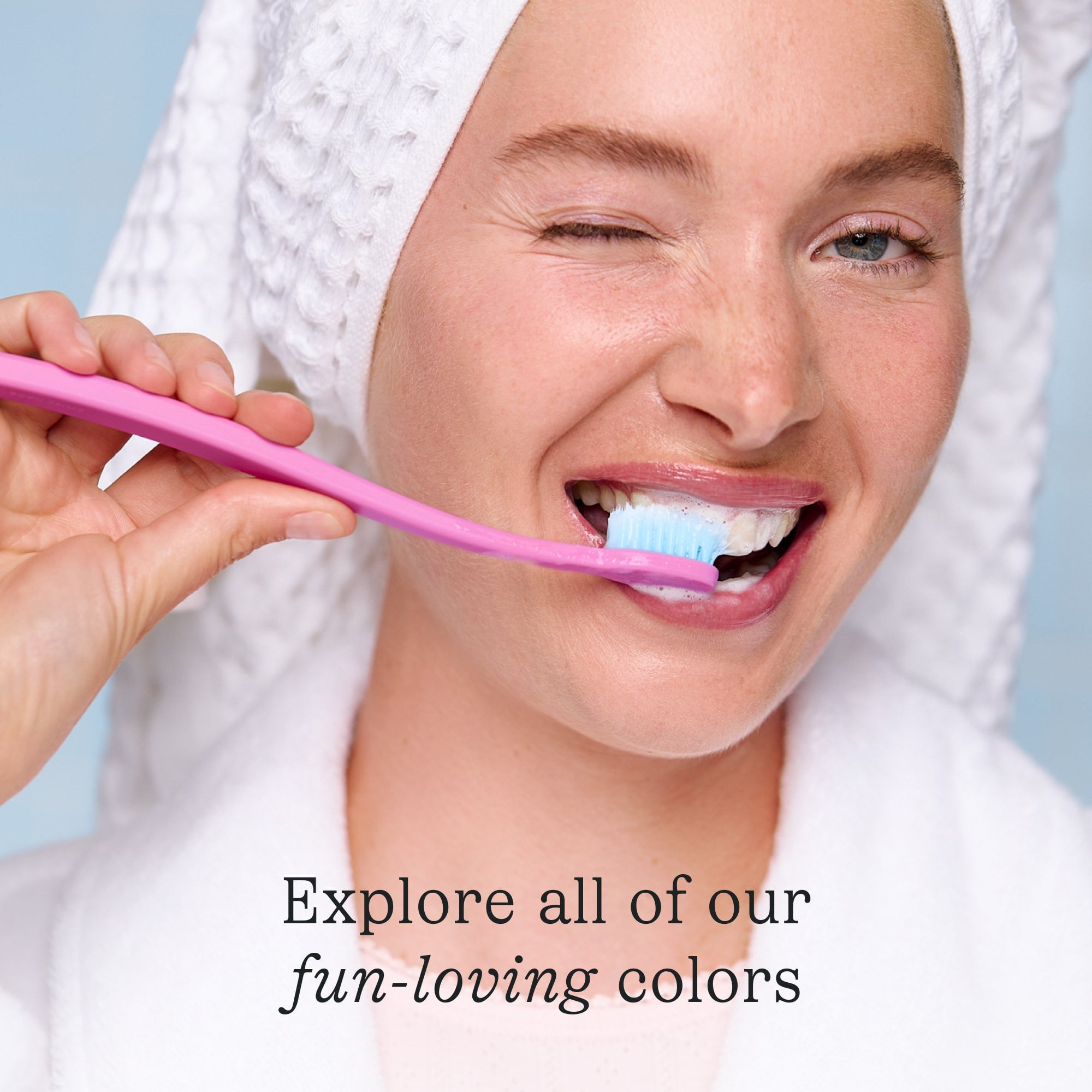 A woman brushing her teeth with a Cocobrush