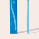 Cocobrush Pool Blue toothbrush with its packaging