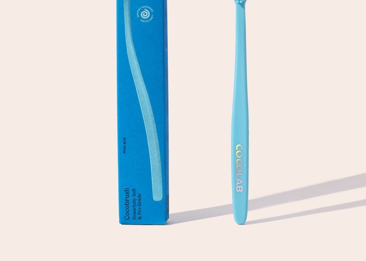 Cocobrush Pool Blue toothbrush with its packaging