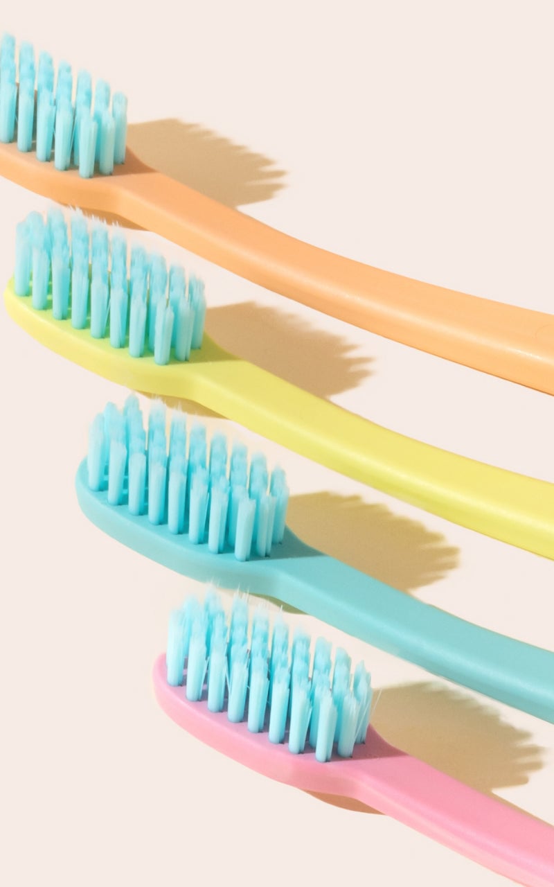 Close view of colorful Cocobrush toothbrushes