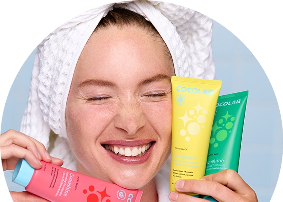 Woman holding Cocofloss oral care products