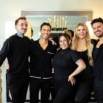 Glamsquad beauty professionals standing together at an event glam suite