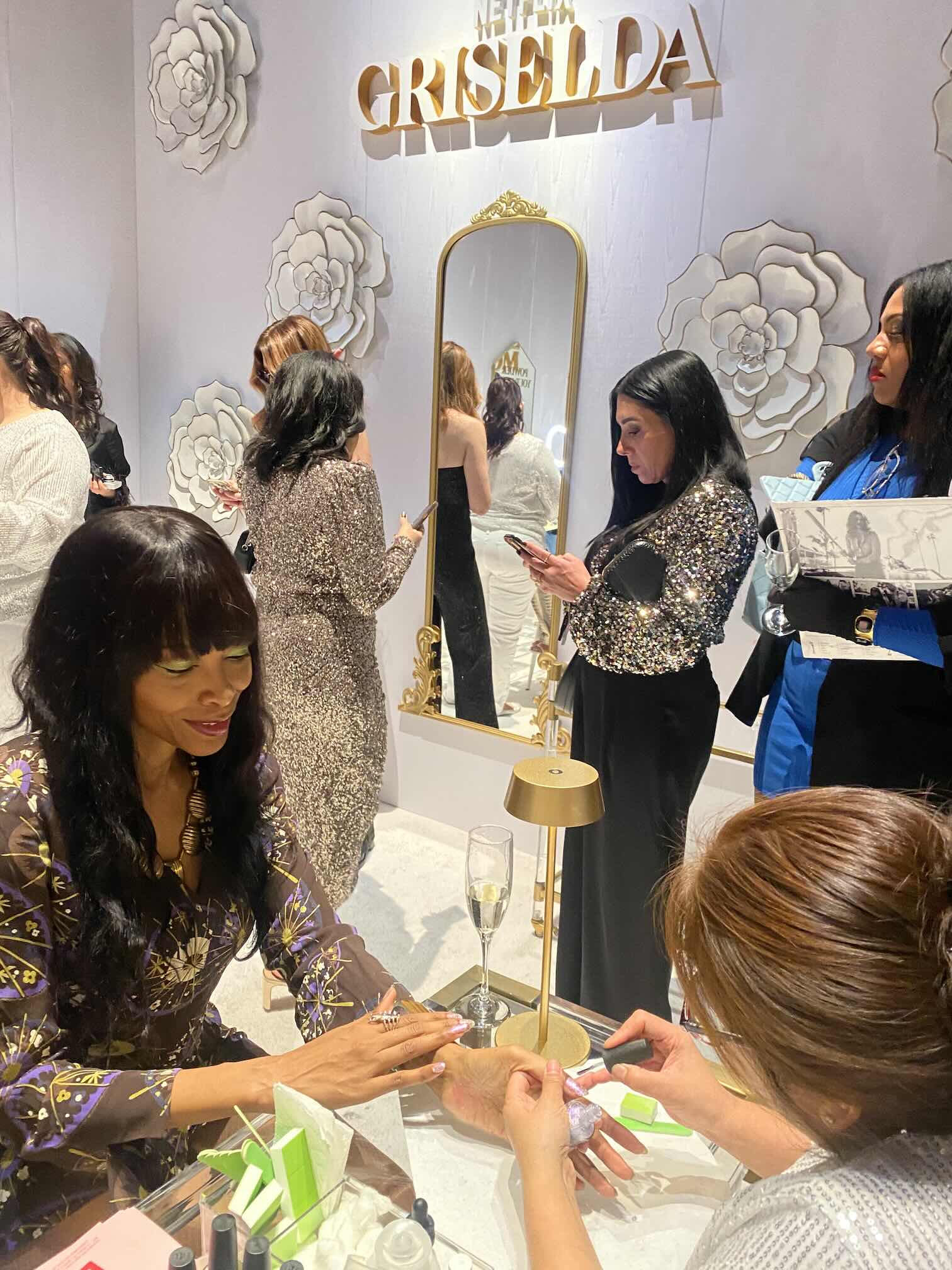 Guest receiving a manicure at an event glam station