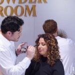 Glamsquad artist applying eye makeup to a guest in an event powder room