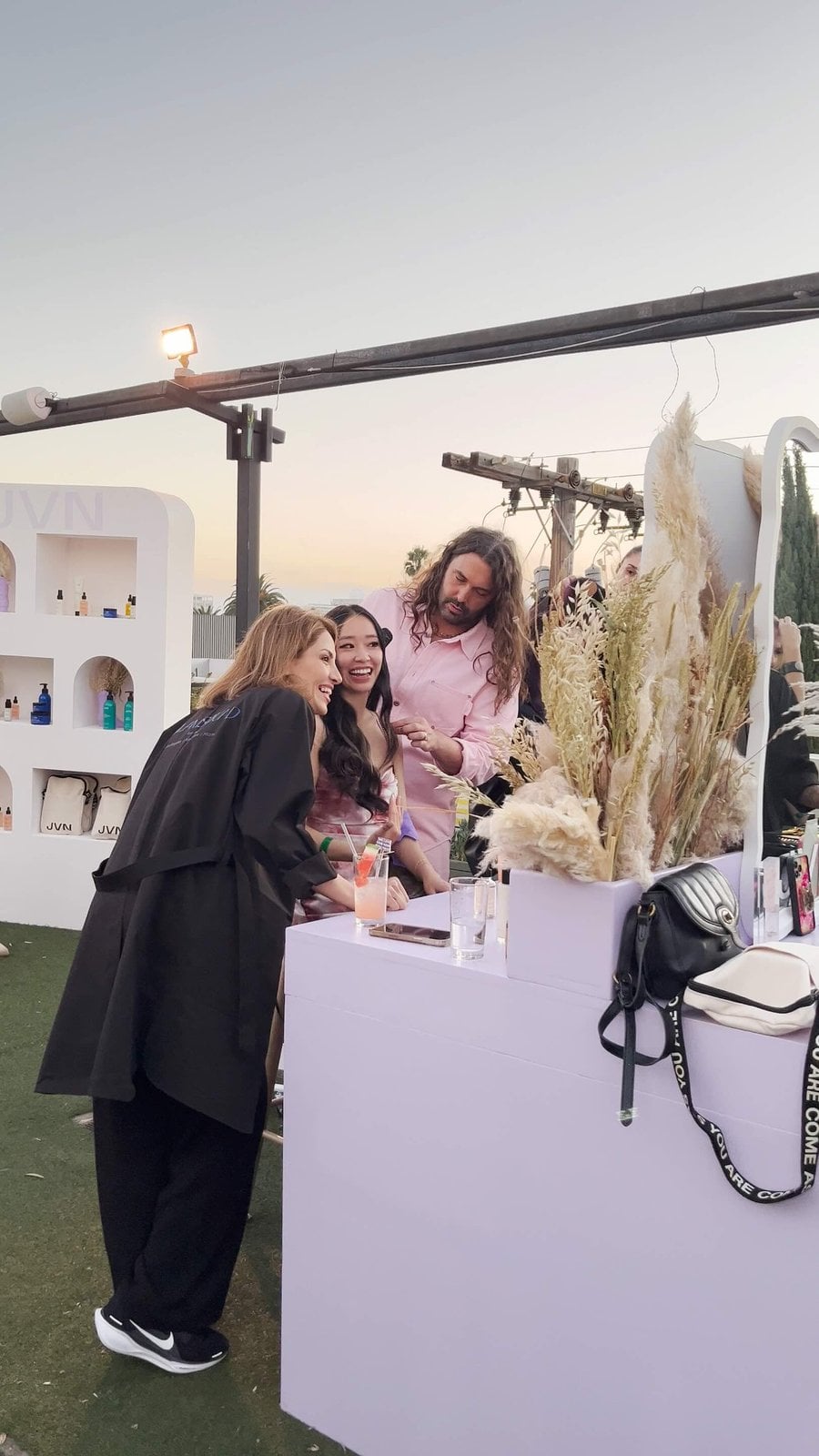 Glamsquad pro with guests at a rooftop beauty bar