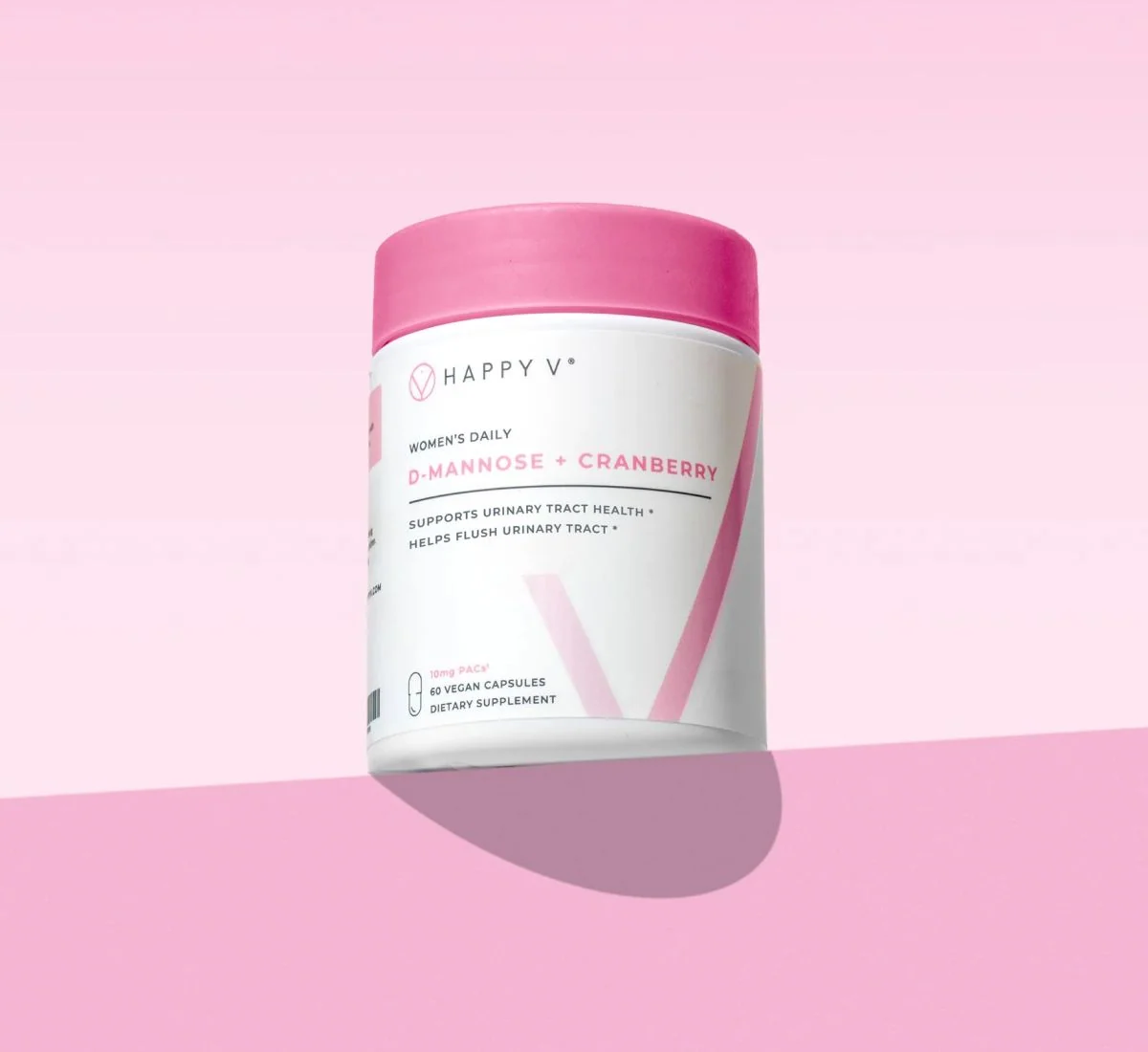 D-Mannose + Cranberry supplement bottle on a colored background
