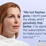 Woman in a white sweater looking thoughtfully to the side