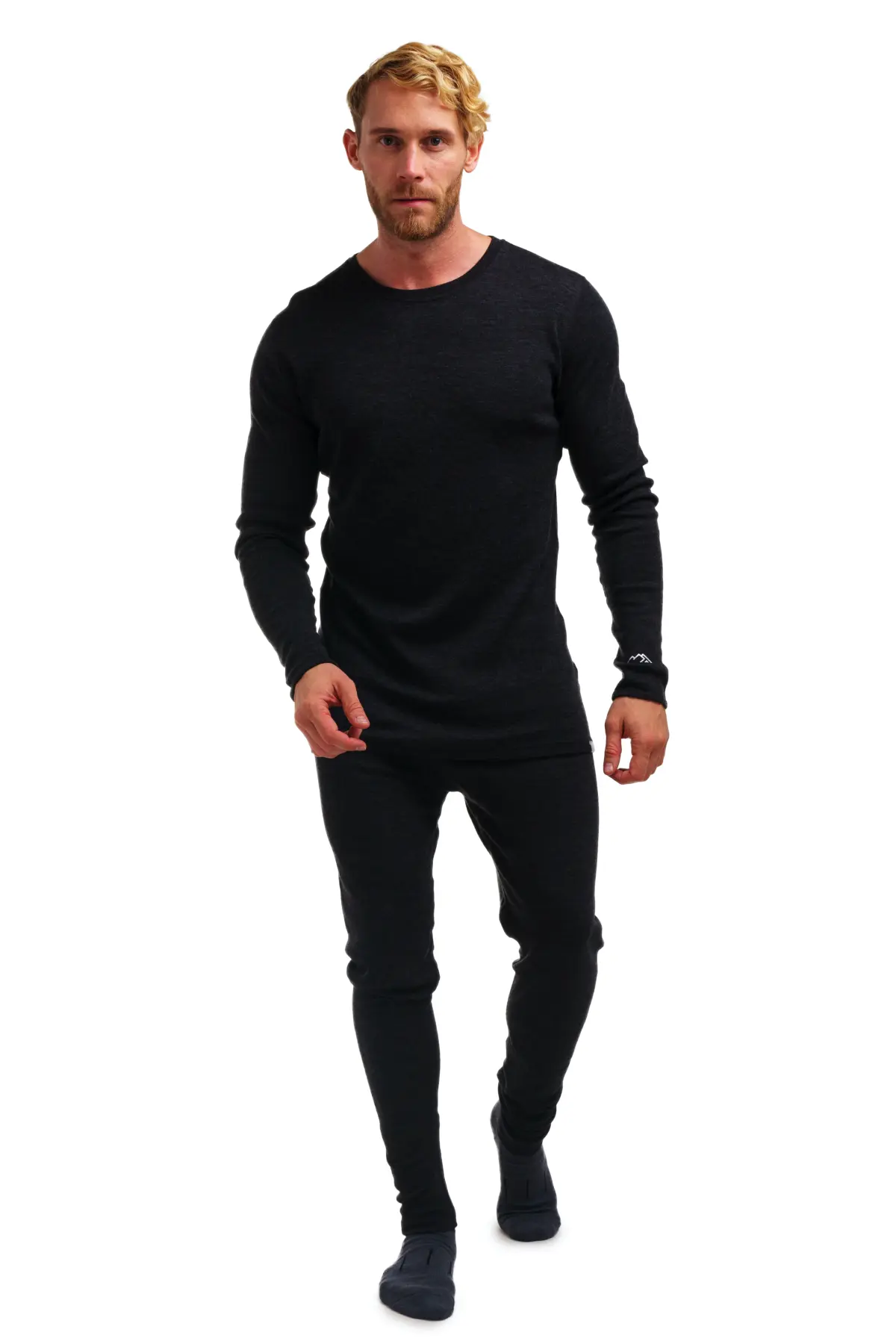 Man modeling a black long-sleeve merino base layer and leggings