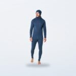 Man wearing a denim blue merino base layer with matching beanie and neck gaiter