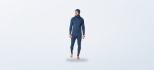 Man wearing a denim blue merino base layer with matching beanie and neck gaiter