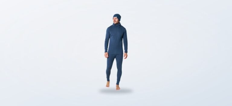 Man wearing a denim blue merino base layer with matching beanie and neck gaiter
