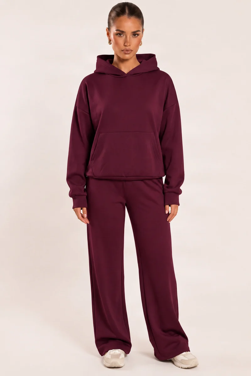 Model wearing a plum oversized hoodie and matching wide-leg joggers