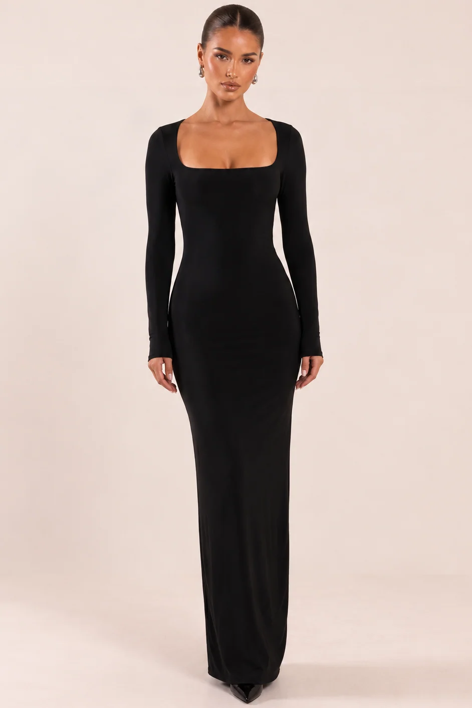 Model wearing a black square neck slinky maxi dress