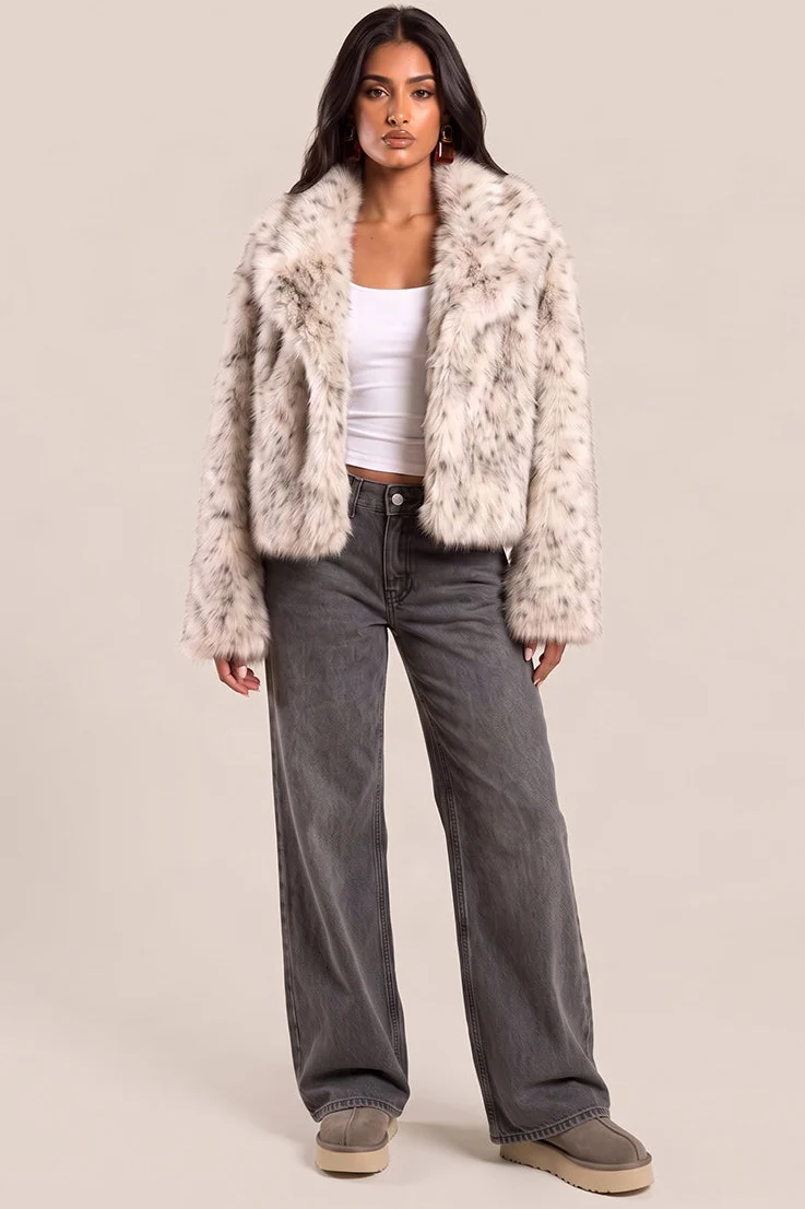 Model wearing a cream leopard faux fur coat