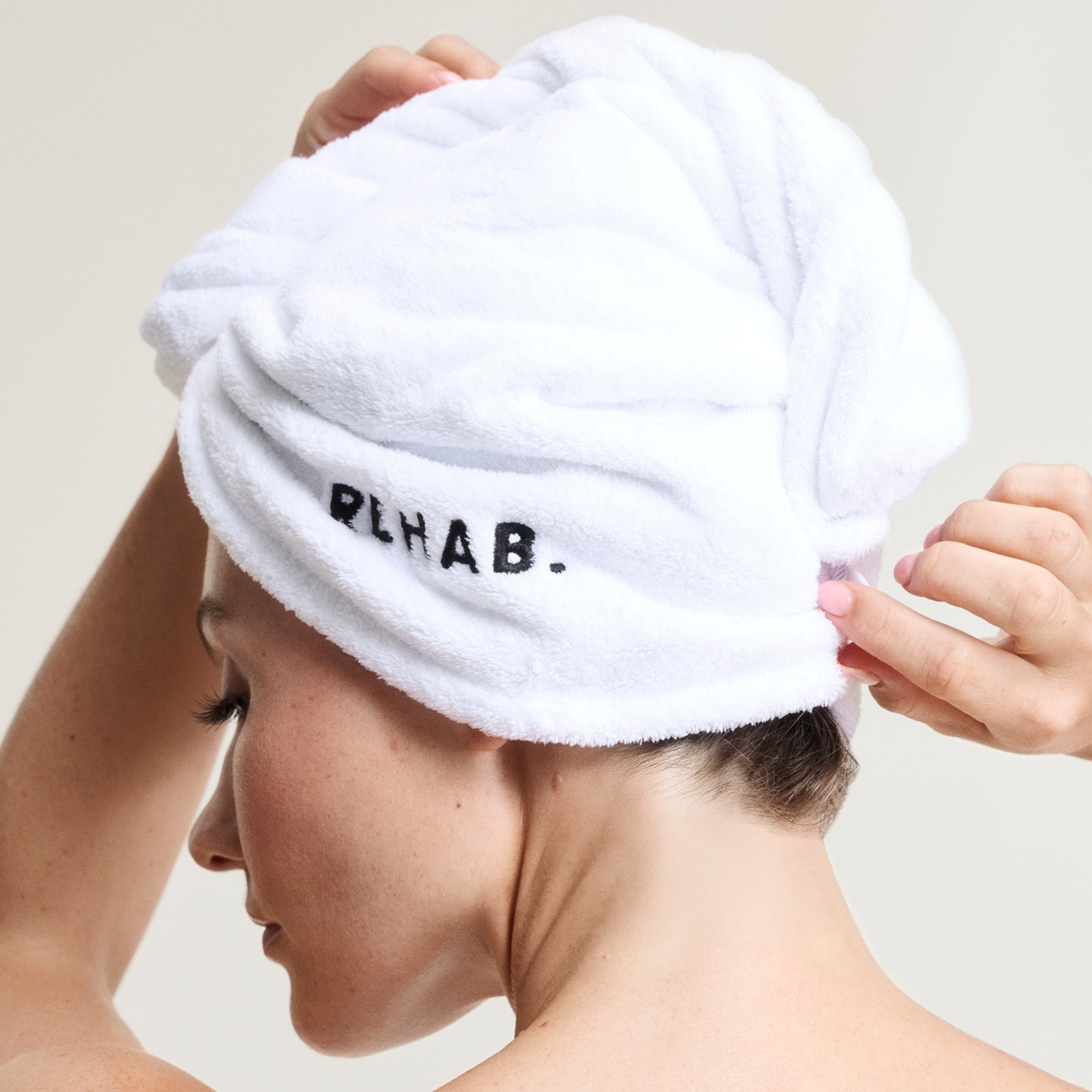 Model wearing a REHAB Your Hair towel