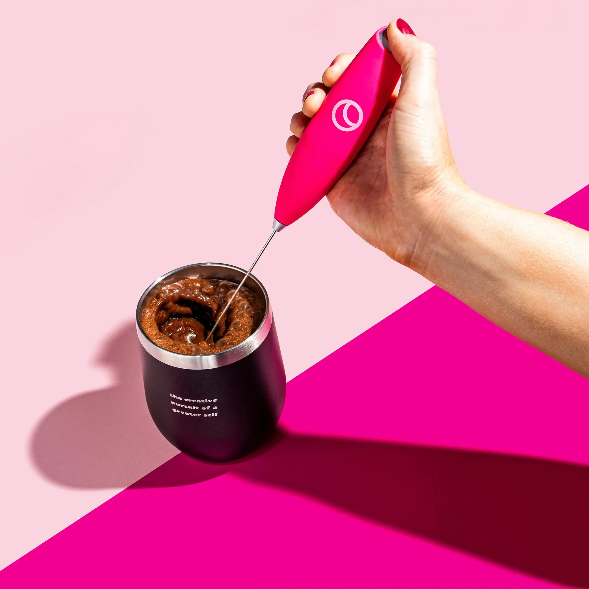 Pink handheld frother for mixing a drink